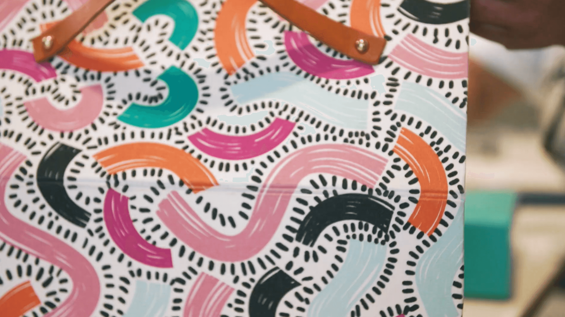 Abstract pattern with colorful wavy lines and dotted details on a white background.
