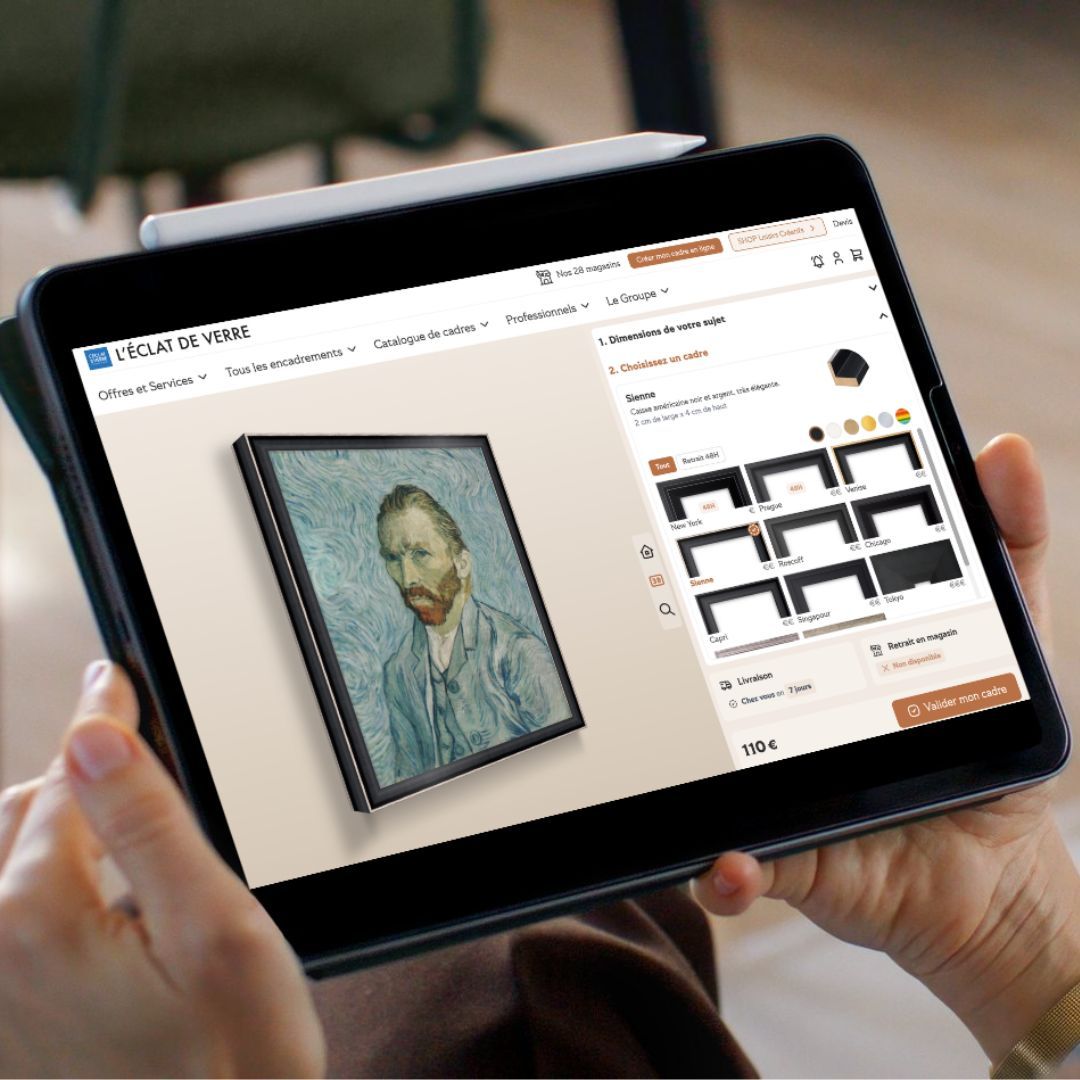 Person holds tablet displaying Van Gogh self-portrait on art framing e-commerce website.