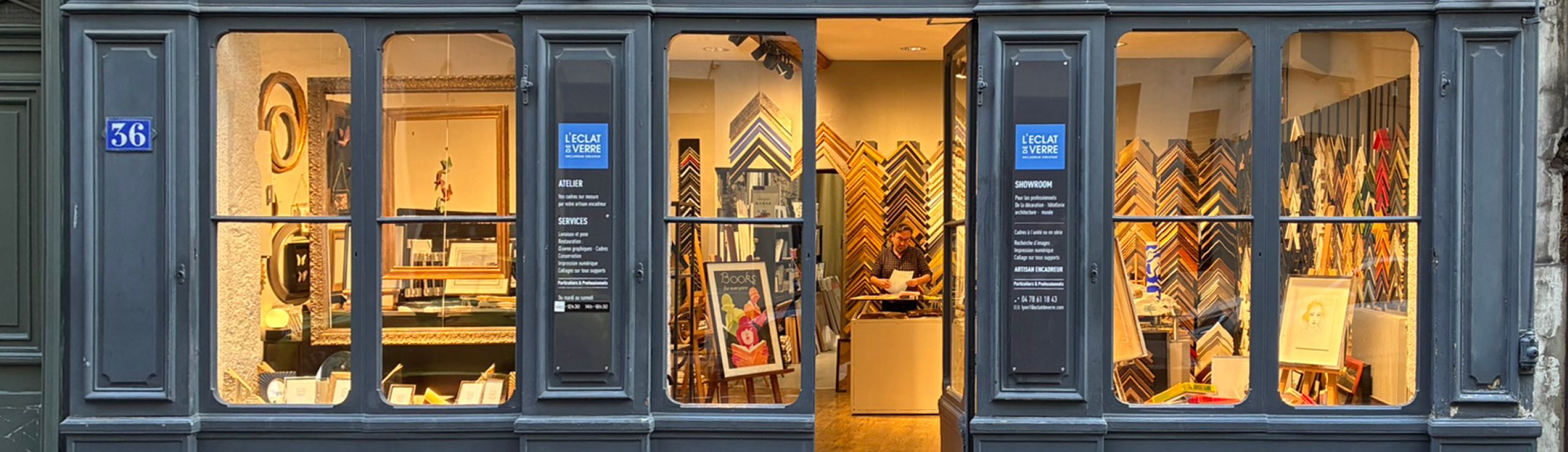 Illuminated storefront windows display various items, with a visible 'SALE' sign.