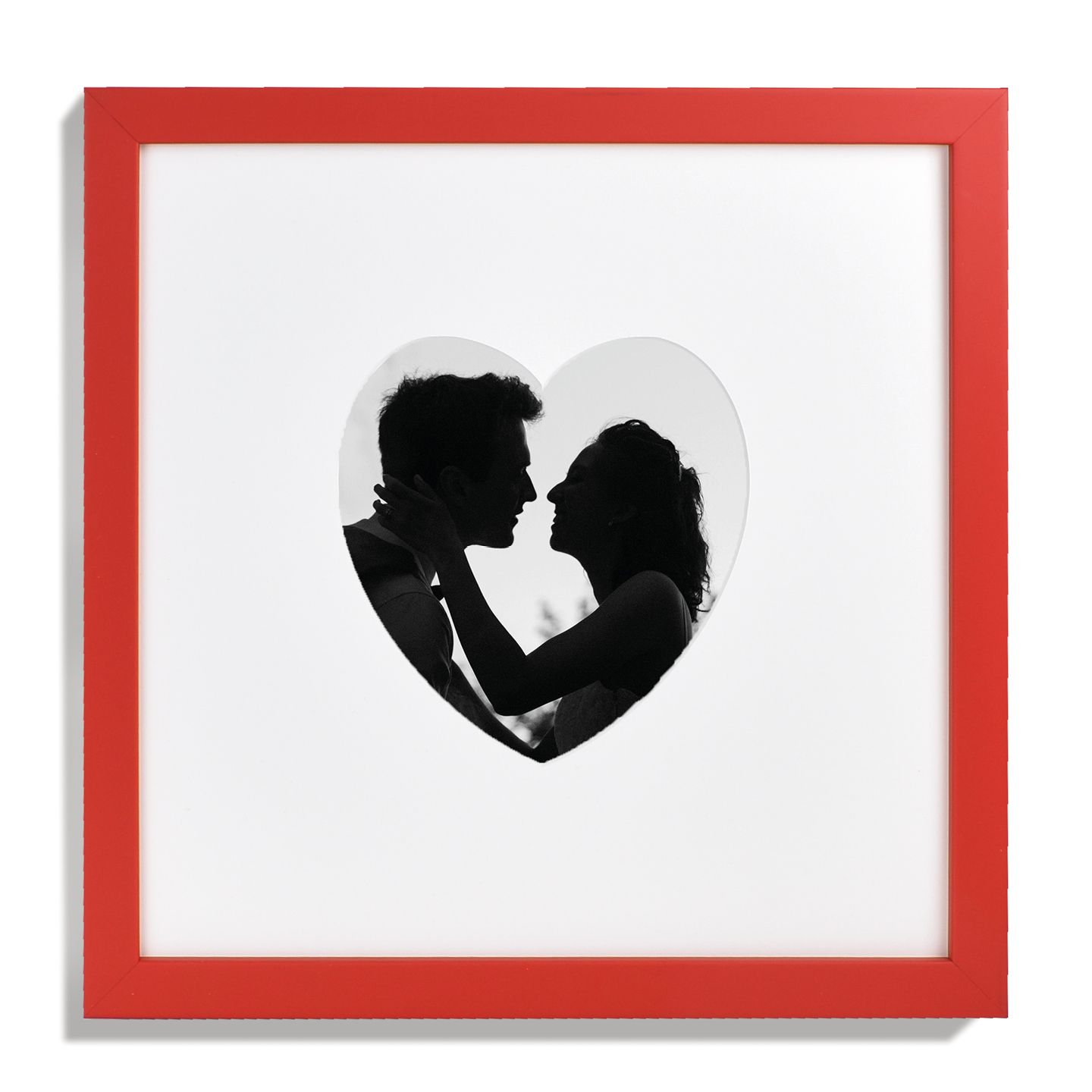 Red framed photo with heart cutout showing a silhouetted couple embracing.