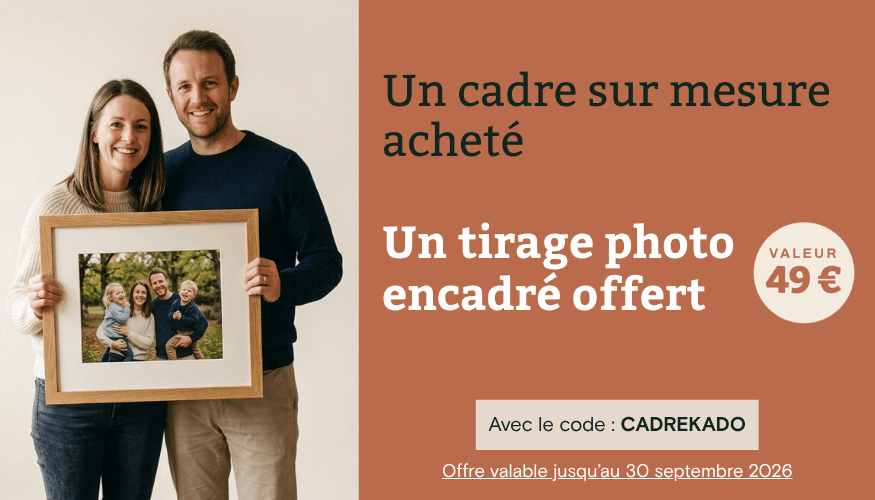 Smiling couple holding a framed family photo, promoting a custom frame offer.