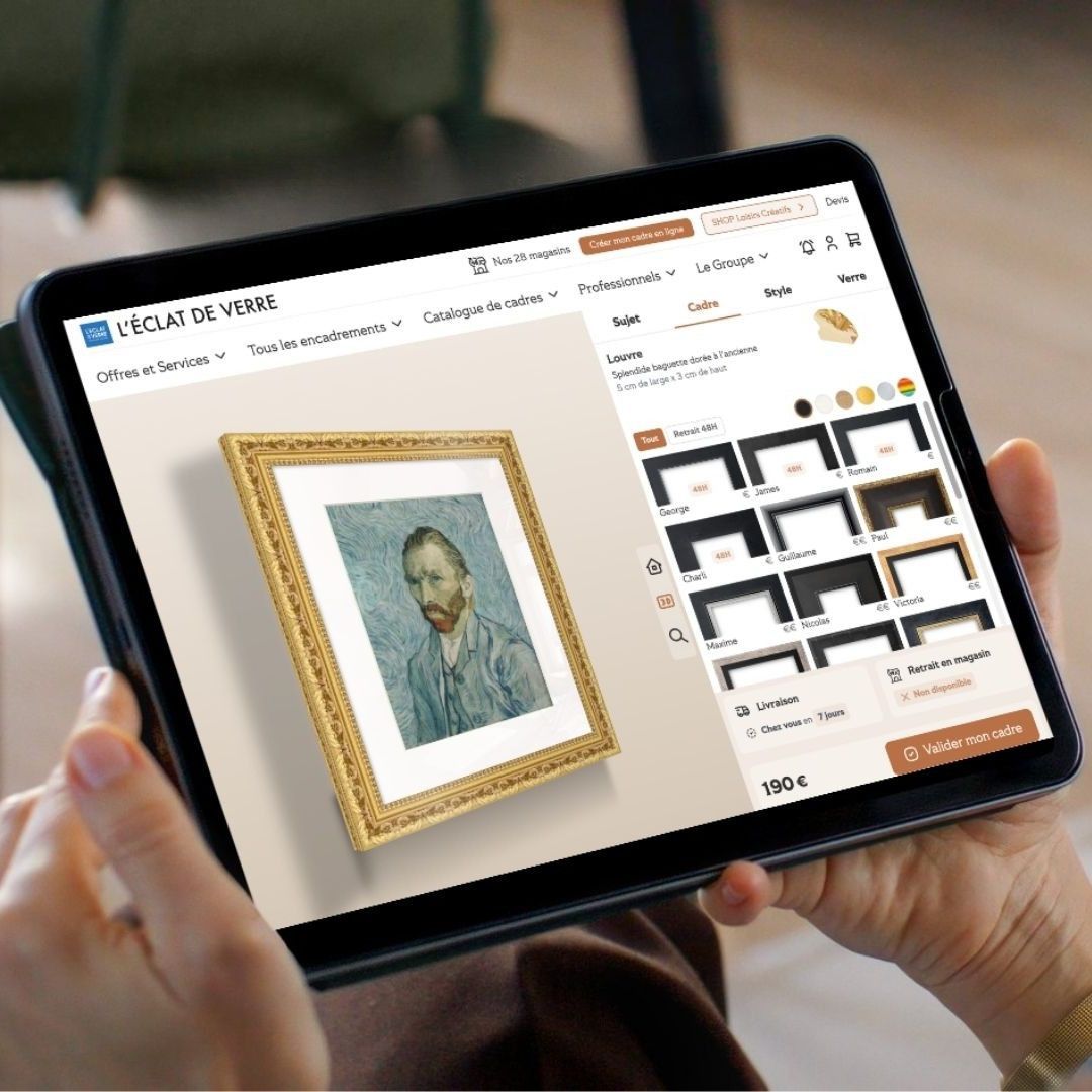 Hands hold a tablet displaying an online store, showing a framed Van Gogh painting and frame style options.