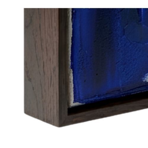 Close-up of a dark wooden frame surrounding a thick, textured blue abstract painting.